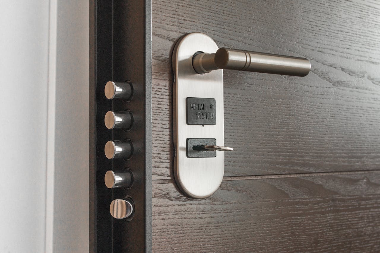 portfolio-05 Metal door handle and lock system with key inserted, showcasing security features.