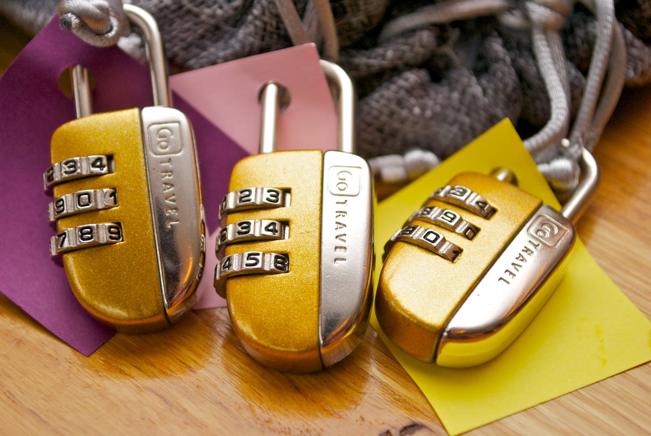 portfolio-04 Three gold combination padlocks with colorful tags, symbolizing security and travel.